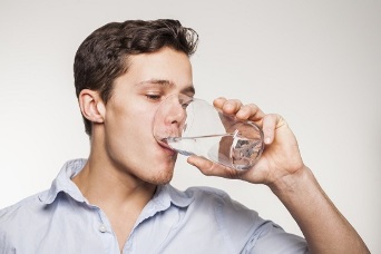 a guide capsule with a glass of water